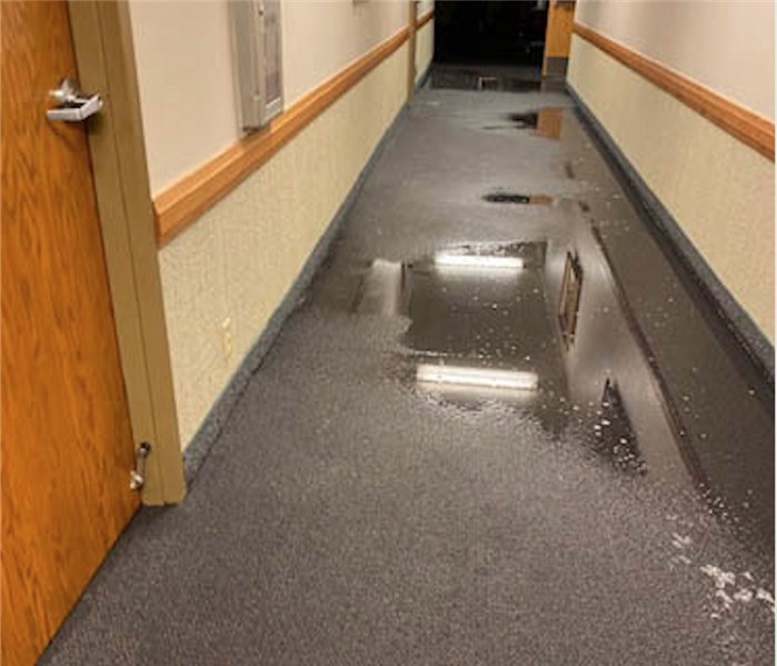 Standing water in a hallway.